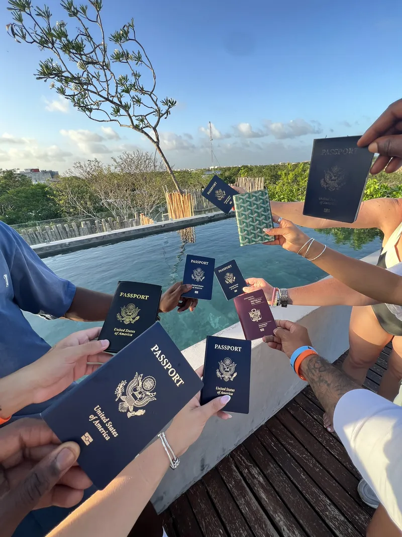 Team holding passports before an incentive trip